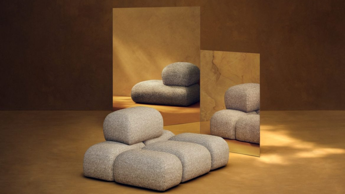 Sculptural Living: H&M HOME x Kelly Wearstler Unveiled at Milan Design Week 1 Sculptural modular Soluna lounge chair in beige textured fabric from the Kelly Wearstler x H&M HOME collection, reflected in warm-toned mirrors within a gallery setting.