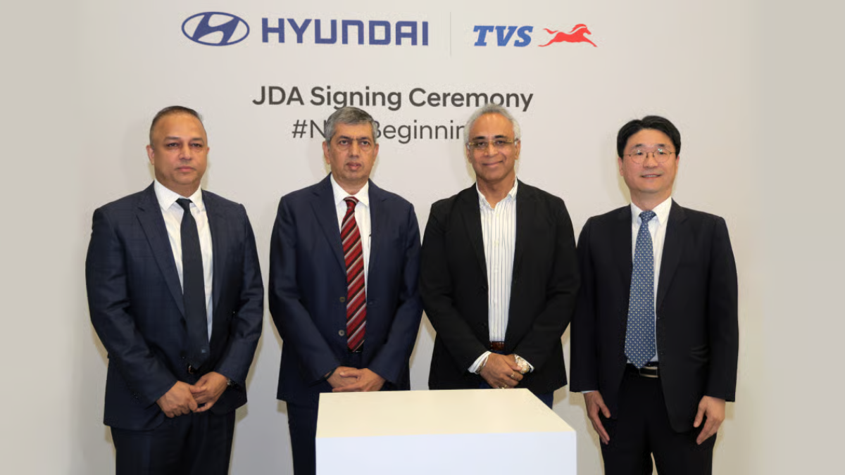 Executives from Hyundai and TVS leadership pose at the JDA signing ceremony for Indian electric three-wheelers.
