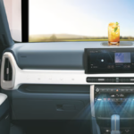 : Interior dashboard of a Hyundai car showing blue airflow graphics from AC vents with a refreshing summer drink on the dash to represent cooling comfort.