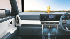 : Interior dashboard of a Hyundai car showing blue airflow graphics from AC vents with a refreshing summer drink on the da...