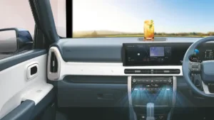 : Interior dashboard of a Hyundai car showing blue airflow graphics from AC vents with a refreshing summer drink on the da...