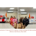 Officials exchange MoU folders (left) and pose with a PIN code reach sign (right) in an office with Indian flags.
