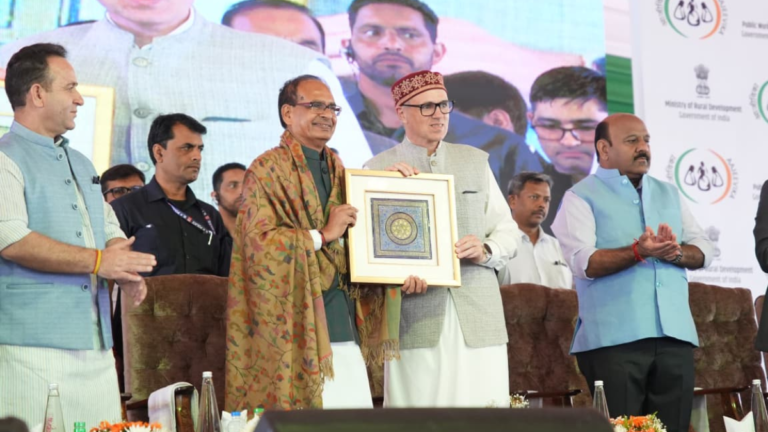 Shivraj Singh Chouhan and Omar Abdullah hold a framed memento at a government event in Srinagar for J&K road projects.