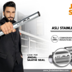 Ranveer Singh in a black suit holding a stainless steel pipe with the Jindal Saathi Seal authenticity mark in India