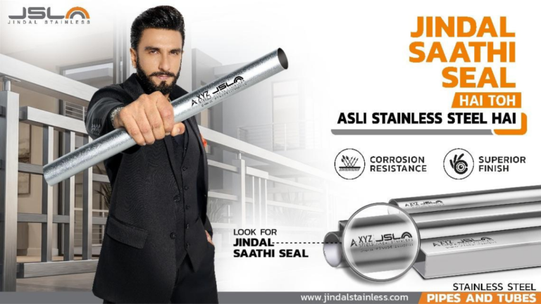 Ranveer Singh in a black suit holding a stainless steel pipe with the Jindal Saathi Seal authenticity mark in India