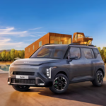 Grey Kia Syros SUV with neon brake callipers and vertical LED lamps in an outdoor setting for the India launch.