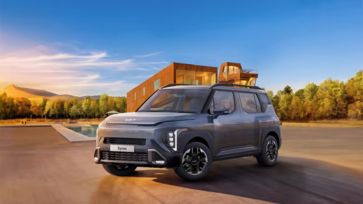Grey Kia Syros SUV with neon brake callipers and vertical LED lamps in an outdoor setting for the India launch.