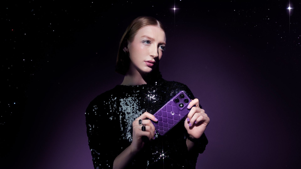 Woman holding a violet motorola signature phone with a 3D-quilted pattern and hand-placed amethyst crystals smartphone