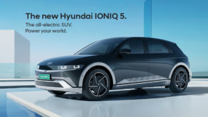 Titan Grey Hyundai IONIQ 5 EV with green Indian number plate in a futuristic architectural setting for launch.
