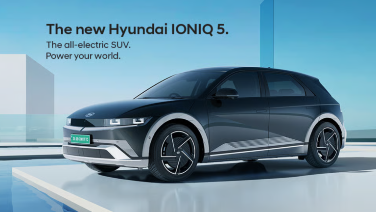 Titan Grey Hyundai IONIQ 5 EV with green Indian number plate in a futuristic architectural setting for launch.