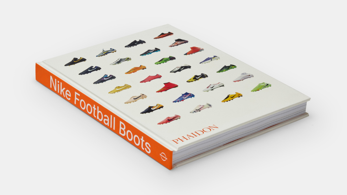 A perspective shot of the 'Nike Football Boots' hardcover book by Phaidon Press, featuring a grid of iconic cleats on a cl...