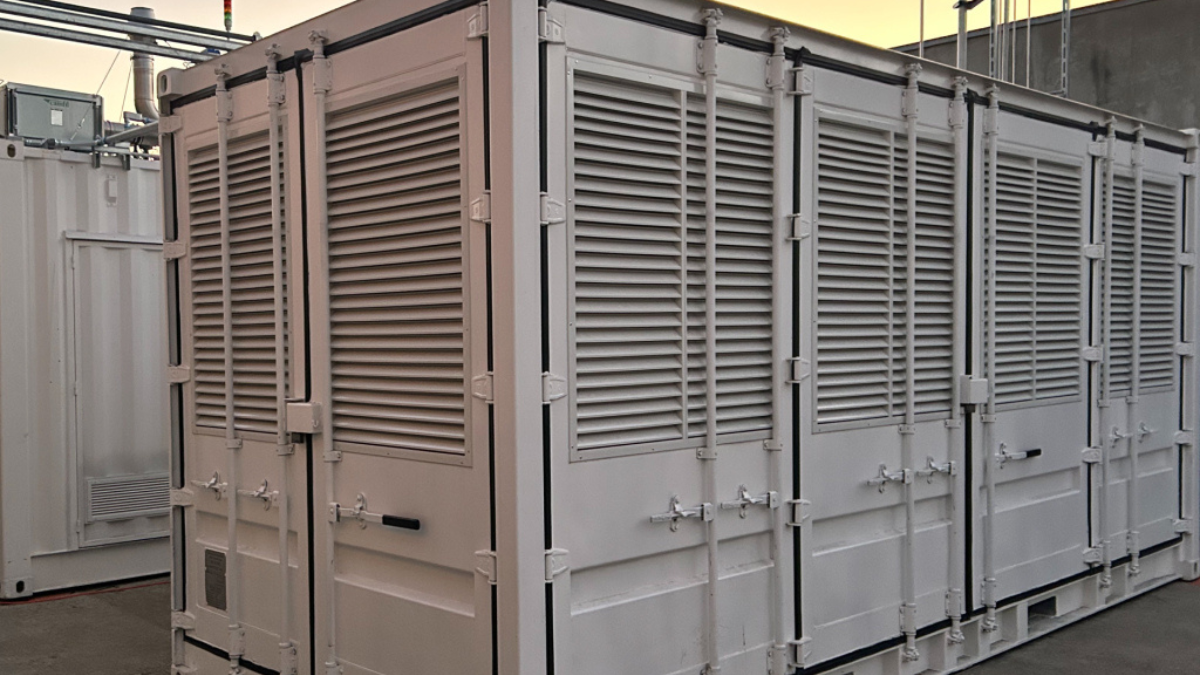 White modular energy storage units with metal vents representing Noon Energy's 100-hour storage for India's AI hubs