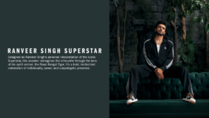 Ranveer Singh wearing a black tracksuit and Superstar sneakers while sitting on a green sofa in a jungle setting in India.