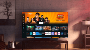 Samsung Smart TV UI featuring Kings of Comedy banner with Kapil Sharma and streaming apps in a modern living room.