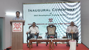 Sandeep Poundrik speaking at a NISST podium during the inauguration ceremony for steel sector training courses in India