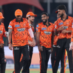SRH players in orange jerseys celebrate a wicket during the TATA IPL 2026 match against CSK in Hyderabad.