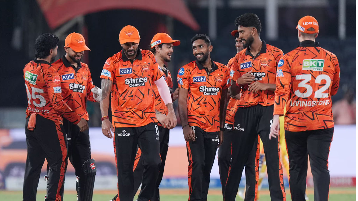 SRH players in orange jerseys celebrate a wicket during the TATA IPL 2026 match against CSK in Hyderabad.