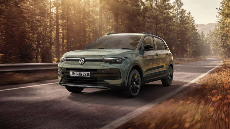 Ditch the Torque Gap: How the New Taigun’s 8-Speed AT Changes the 1.0L TSI Game 1 Front three-quarter view of the sage green Volkswagen Taigun driving on a sun-drenched forest road.