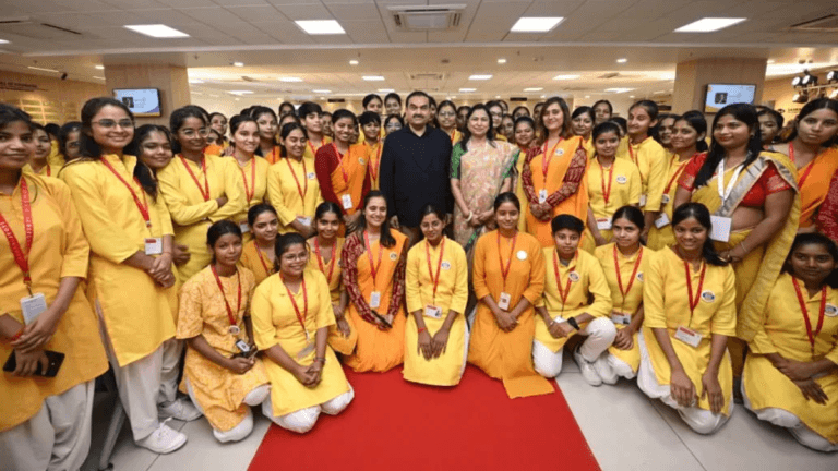 Will Adani's healthcare push change rural access in Bihar? 1 Gautam and Priti Adani with a large group of female trainees in yellow uniforms during the new Bihar eye hospital launch.