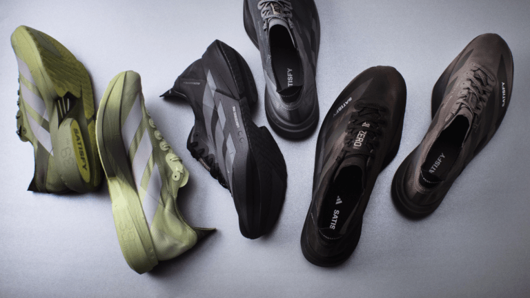 A top-down view of five adidas and Satisfy running shoes in olive green, earth brown, and black colourways.