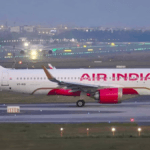 Air India A320 aircraft taxiing on a lit runway at dusk for the new Halwara flight service launch in Punjab.