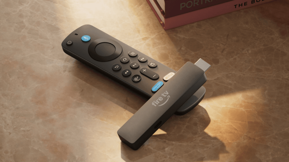 At ₹4,999, Amazon's slimmest stick drops the wall adapter 1 Amazon Fire TV Stick dongle resting on its voice remote on a sunlit marble table, representing the new India launch.