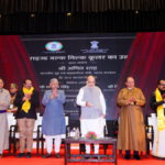 Officials on stage with a backdrop for dairy infrastructure inauguration in Leh Ladakh.