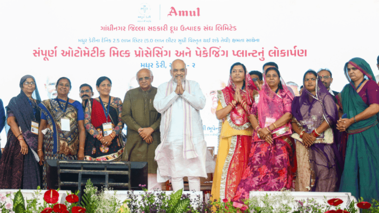 National milk production is set to triple over ten years 4 Amit Shah, Bhupendra Patel, and women cooperative leaders on stage at the Madhur Dairy plant launch in India.