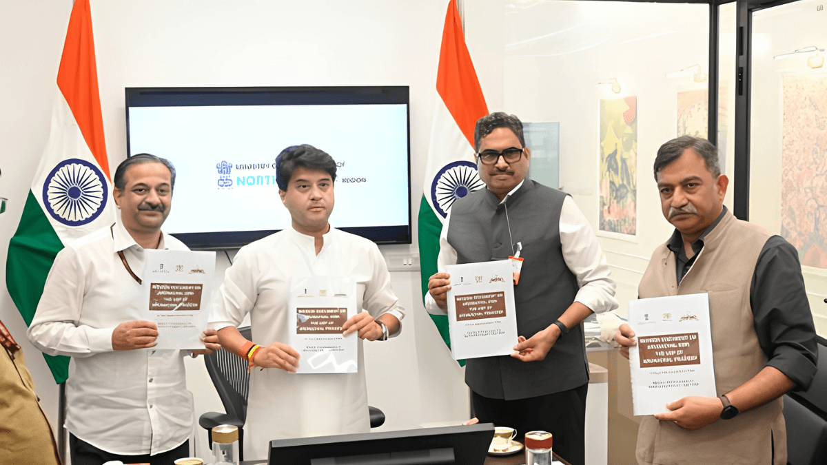 How a ₹167 crore fund could alter the fruit you buy 2 Union Minister Jyotiraditya Scindia and officials hold mission booklets inside an office with Indian flags and digital screen.