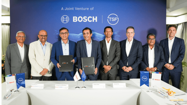 Why are industrial giants rebuilding commercial vehicle brakes? 1 Executives holding signed folders in front of a Bosch and TSF Joint Venture backdrop during a commercial vehicle launch ev...