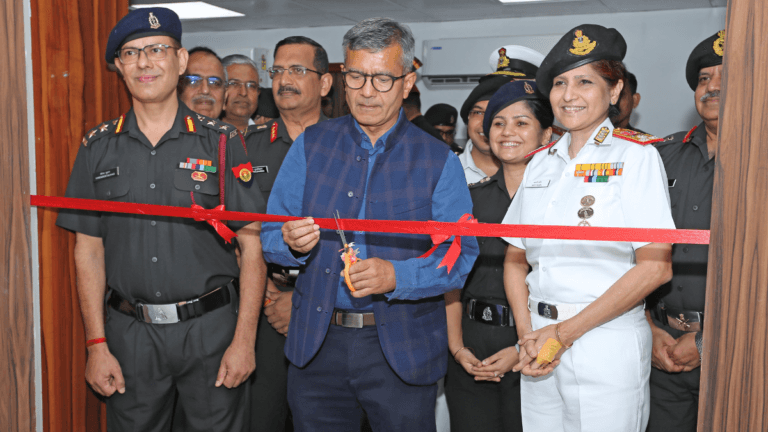 Defence Secretary cutting a red ribbon alongside senior military officers to open the new radiotherapy facility in Delhi.