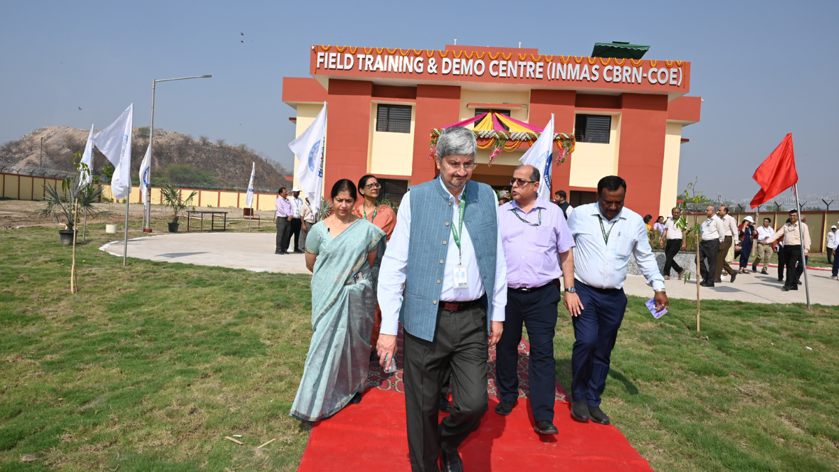 Officials walk on a red carpet in front of the DRDO Field Training & Demo Centre building in Delhi.