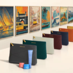 Seven coloured amenity pouches in a row with gold zippers and Etihad logo, opposite seven matching framed travel art pieces.