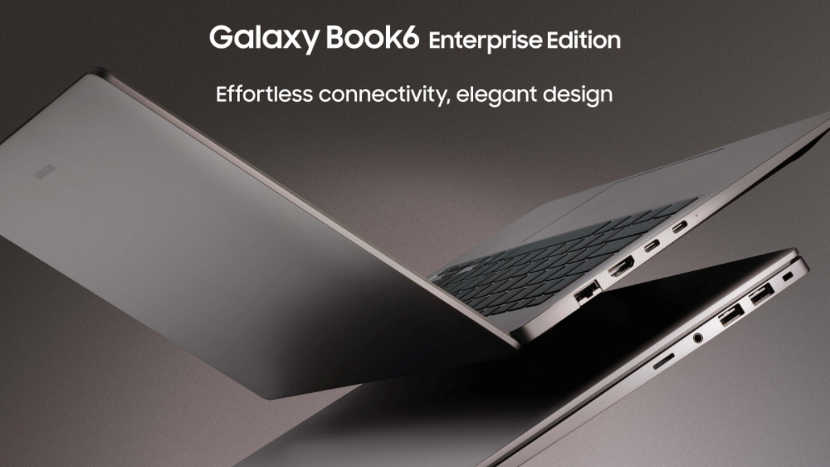 Galaxy Book6 Enterprise Edition Offers 24-Hour Battery 1 Two Mocha Gray Galaxy Book6 Enterprise Edition laptops showing thin side profiles and ports against a dark business backdrop.