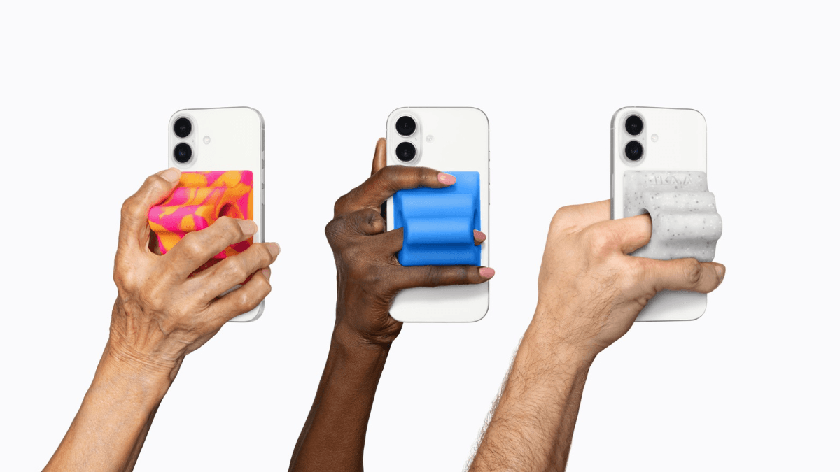 Three diverse hands holding white iPhones fitted with chunky pink, blue, and grey textured silicone MagSafe back grips.