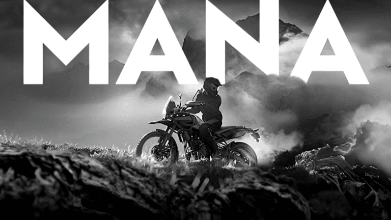 Royal Enfield prices the new Himalayan Mana Black at ₹3.37 lakh 2 Rider in black kit on a Royal Enfield Himalayan motorcycle amidst misty Indian mountain peaks, with "MANA" text above.