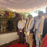 Officials standing by a flower-adorned inauguration plaque with multilingual text at the Vizag C-ART facility.