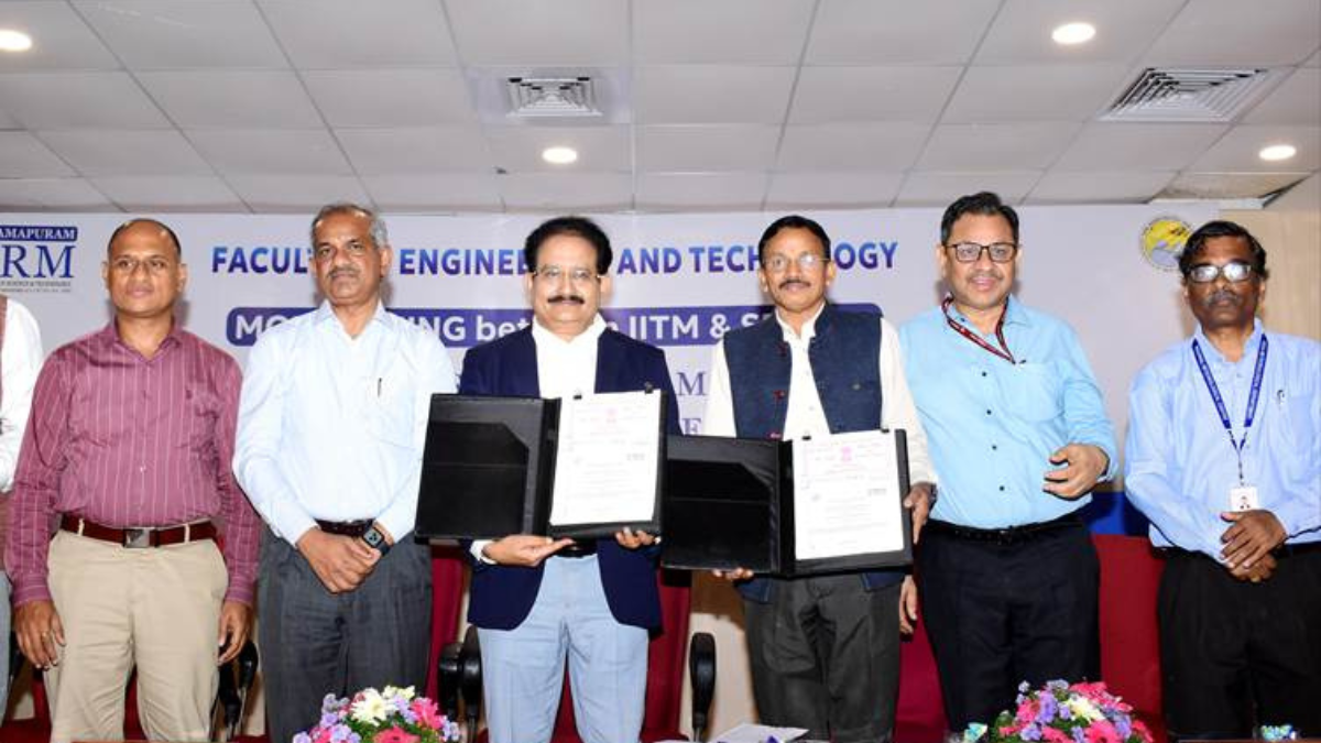 Officials from IITM and SRMIST holding signed folders during a Memorandum of Understanding ceremony for weather research.