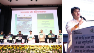 Group holding handbooks and Minister Scindia speaking, showing the launch of India's new disaster guidelines.