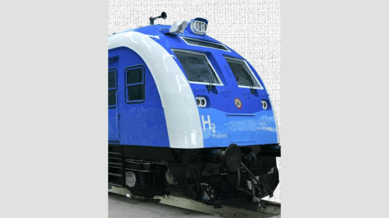 Front view of a blue and white train engine with H2 Powered text and Indian Railways logo on a textured background.