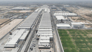 Aerial view of the massive white industrial buildings and parking lots at the Maruti Suzuki Kharkhoda manufacturing facili...