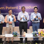 Five officials holding booklets on a stage before a From Patent 2 Product banner at the MeitY IP Catalyst launch.