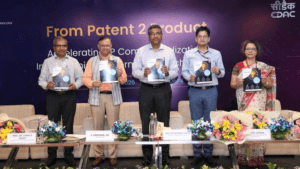 Five officials holding booklets on a stage before a From Patent 2 Product banner at the MeitY IP Catalyst launch.