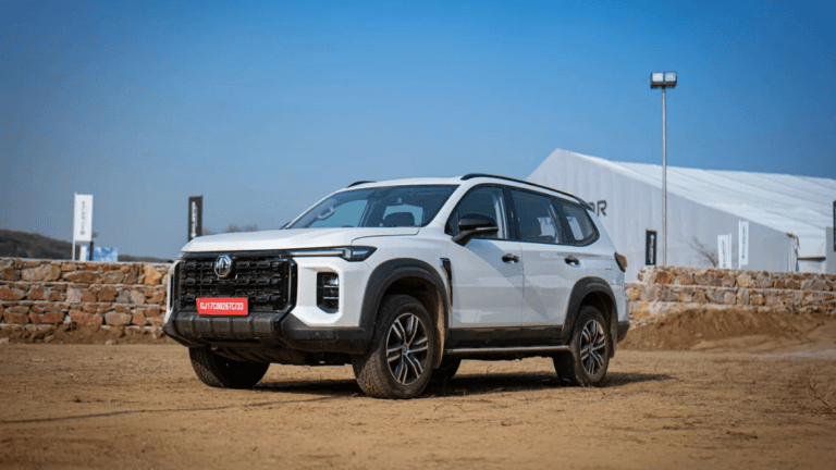 White MG Majestor SUV parked on a dirt lot near a white event tent during its Indian market launch.