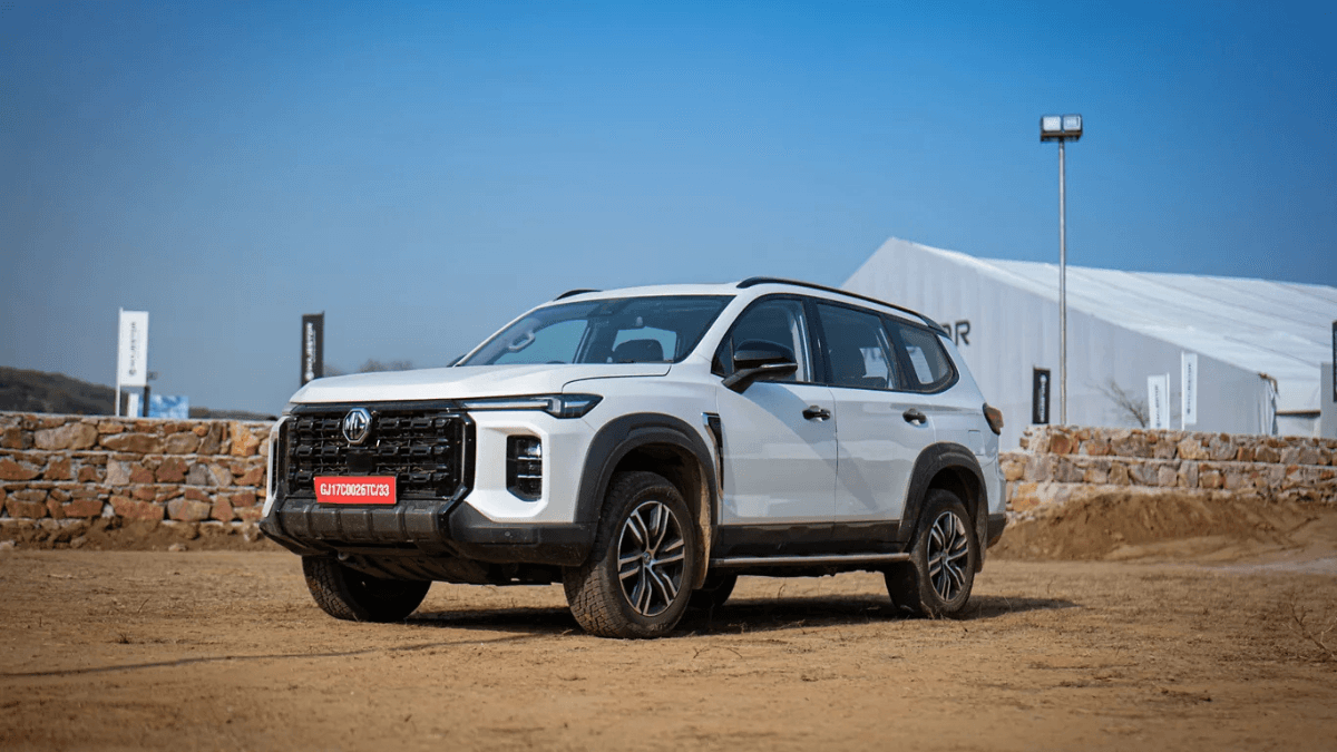 White MG Majestor SUV parked on a dirt lot near a white event tent during its Indian market launch.