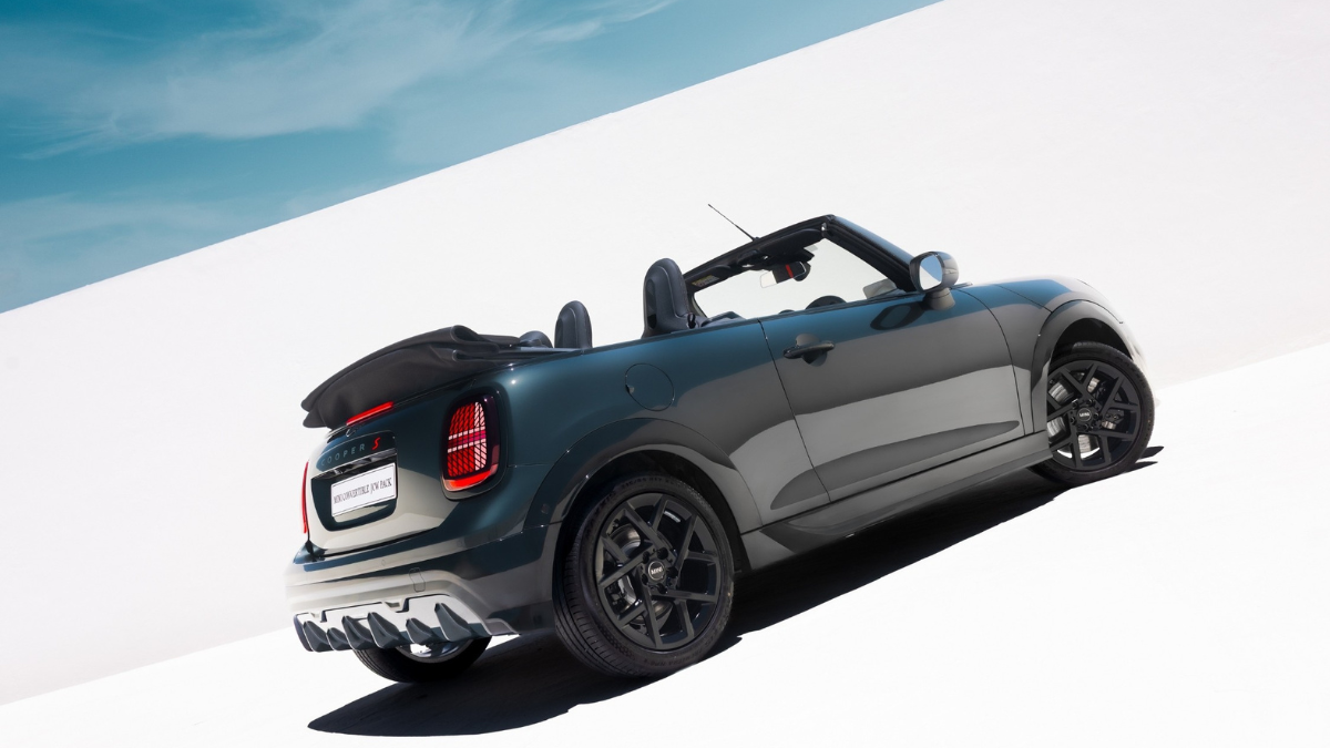 Rear view of the dark grey MINI Convertible with the top down, highlighting the LED taillights and black alloys in India.