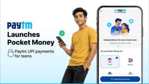 Smiling young man holding a phone next to a smartphone displaying the Paytm Pocket Money app setup interface in India.