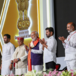 PM Narendra Modi with officials on stage at the PM MITRA Park inauguration event in Warangal Telangana.