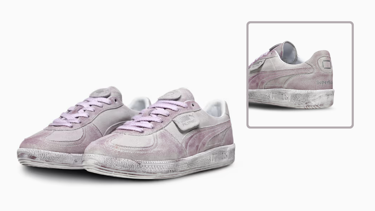 Faded purple suede PUMA sneakers with a distressed finish and white laces on a white background