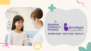 Smiling girl in pink shirt interacting with a doctor beside Rainbow Hospital and BirthRight logos in Bengaluru.